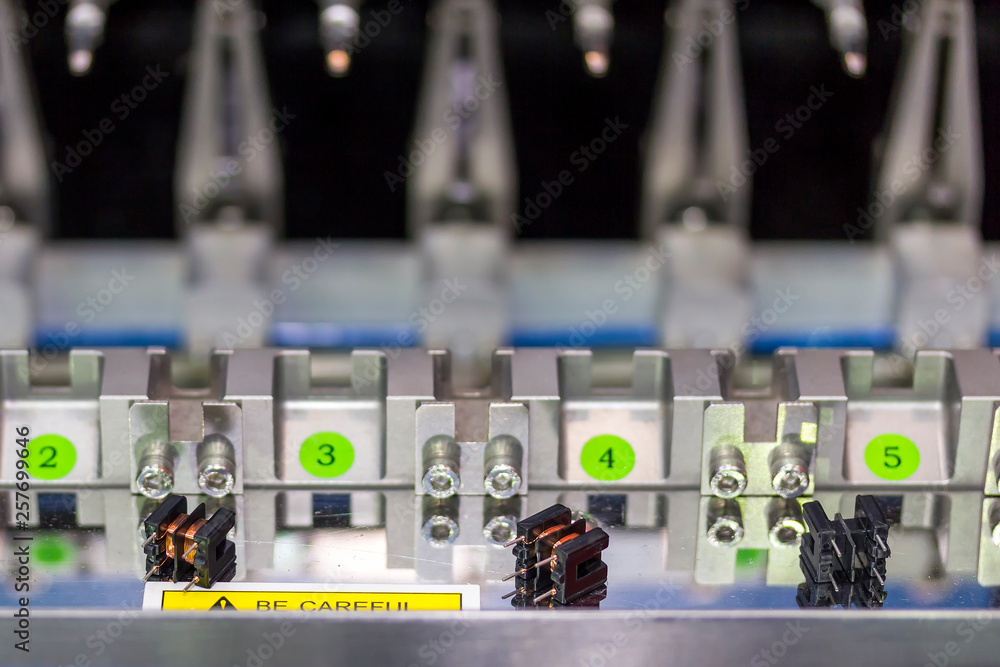 Obraz premium Close up small electric transformer at high precision and accuracy of multiple automatic coil winding machine