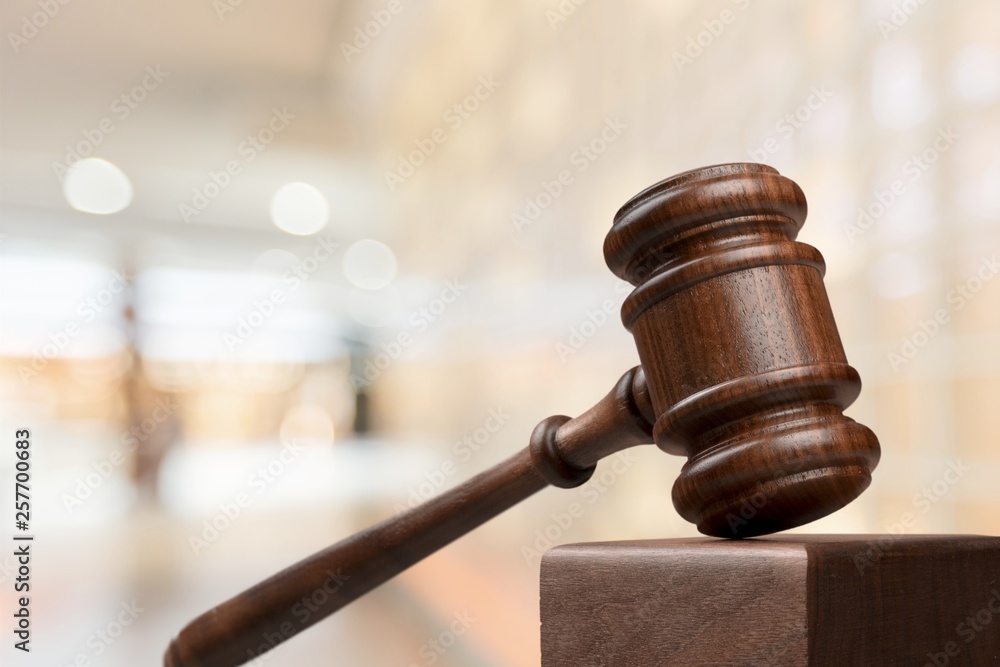 Judge hammer and documents on room background, bokeh background Judge hammer and documents on room background, bokeh background