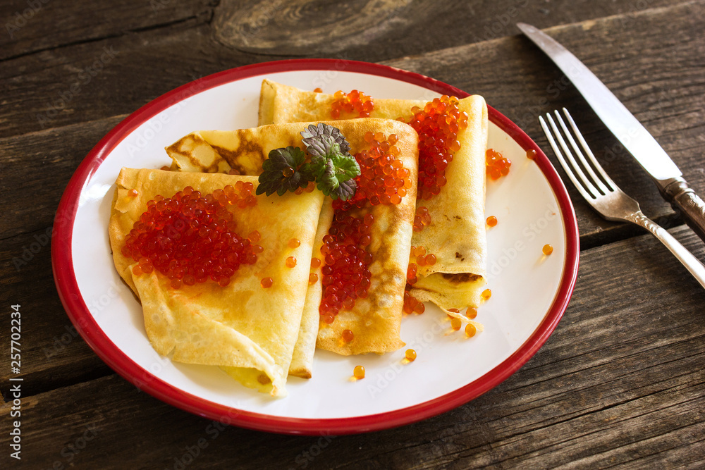 Tasty crepes with caviar. French crepes, russian or ukrainian on white background. Maslenitsa holiday food