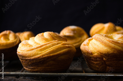 Modern fashionable pastries - scones cruffins (puffmaffin) a mixture of a croissant and maffin photo