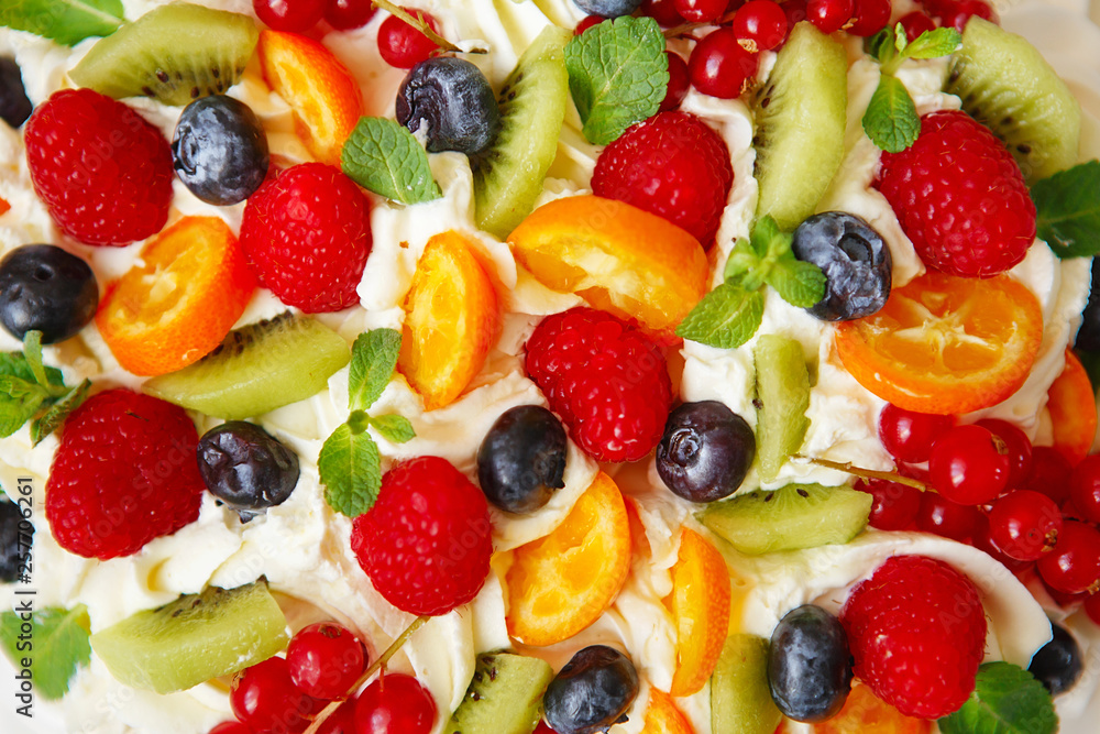 Pavlova cake with cream and fresh summer berries. Close up of Pavlova dessert with forest fruit and mint. Pavlova cake with cream and fresh summer berries. Close up of Pavlova dessert with forest fruit and mint.