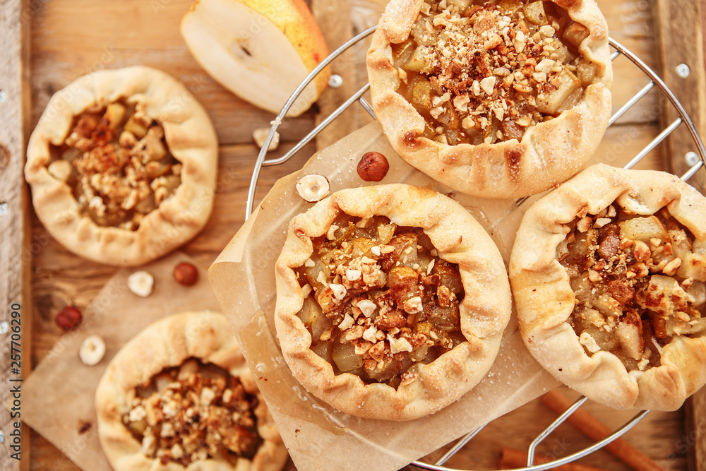 Caramelized pear rustic pie on wooden background, top view. Caramelized pear rustic pie on wooden background, top view.