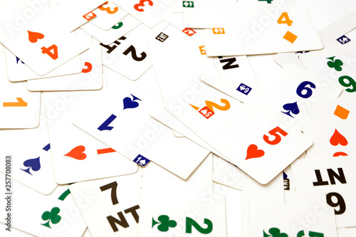 Cards for bridge of different colors on a white background. Equipment for a sports game of bridge. Betting concept. Corruption in sports. A bribe in the game, a bribe in real life.
