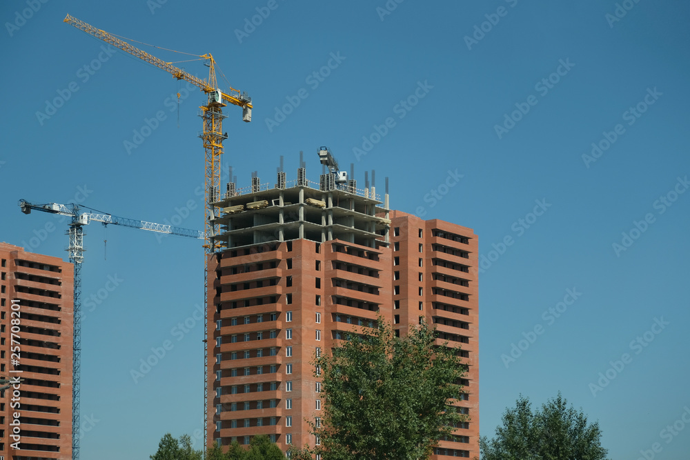 construction of high-rise buildings. crane on the background of the sky. construction of high-rise buildings. crane on the background of the sky.