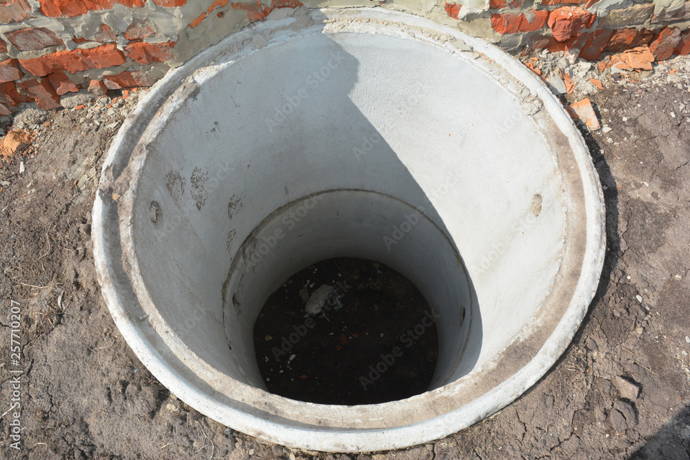 Concrete septic tank. Sewer tank hole installation outdoors Concrete septic tank. Sewer tank hole installation outdoors
