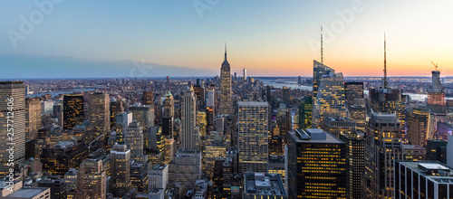 Panoramic photo of New York City Skyline in Manhattan downtown with Empire State Building and skyscrapers at night USA