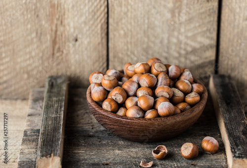Hazelnuts on rustic wooden background. Food background. Print for kitchen