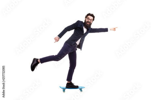 bearded businessman riding a skateboard, isolated on white background