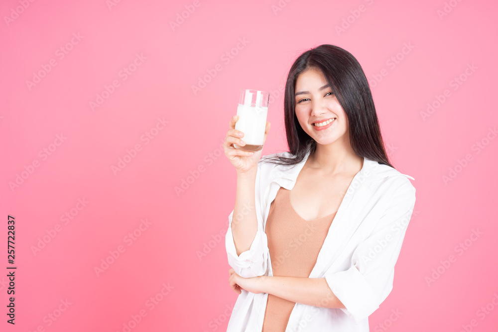 beauty woman Asian cute girl feel happy drinking milk for good health in the morning on pink background - lifestyle beauty woman c beauty woman Asian cute girl feel happy drinking milk for good health in the morning on pink background - lifestyle beauty woman c