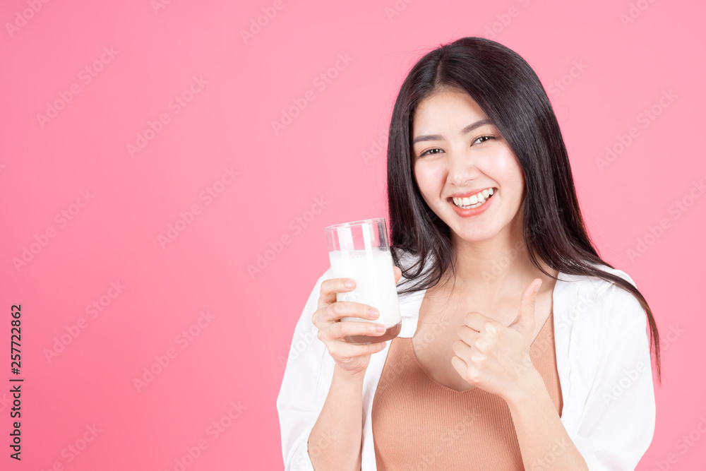 beauty woman Asian cute girl feel happy drinking milk for good health in the morning on pink background - lifestyle beauty woman c beauty woman Asian cute girl feel happy drinking milk for good health in the morning on pink background - lifestyle beauty woman c