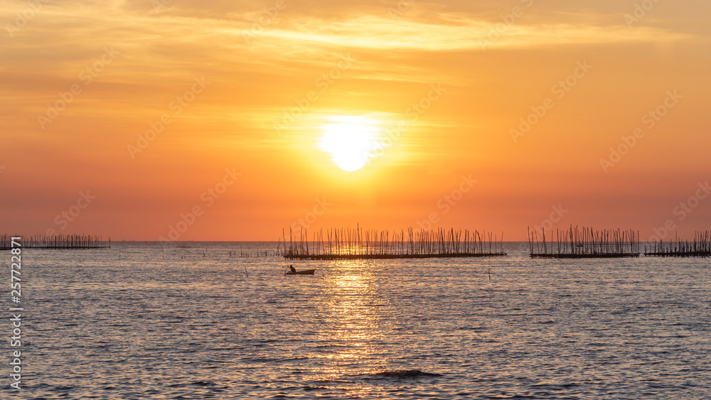 Oyster farm in the sea and beautiful sky sunset background , sun and clouds Landscape nature ,seascape at chonburi  province  Thailand