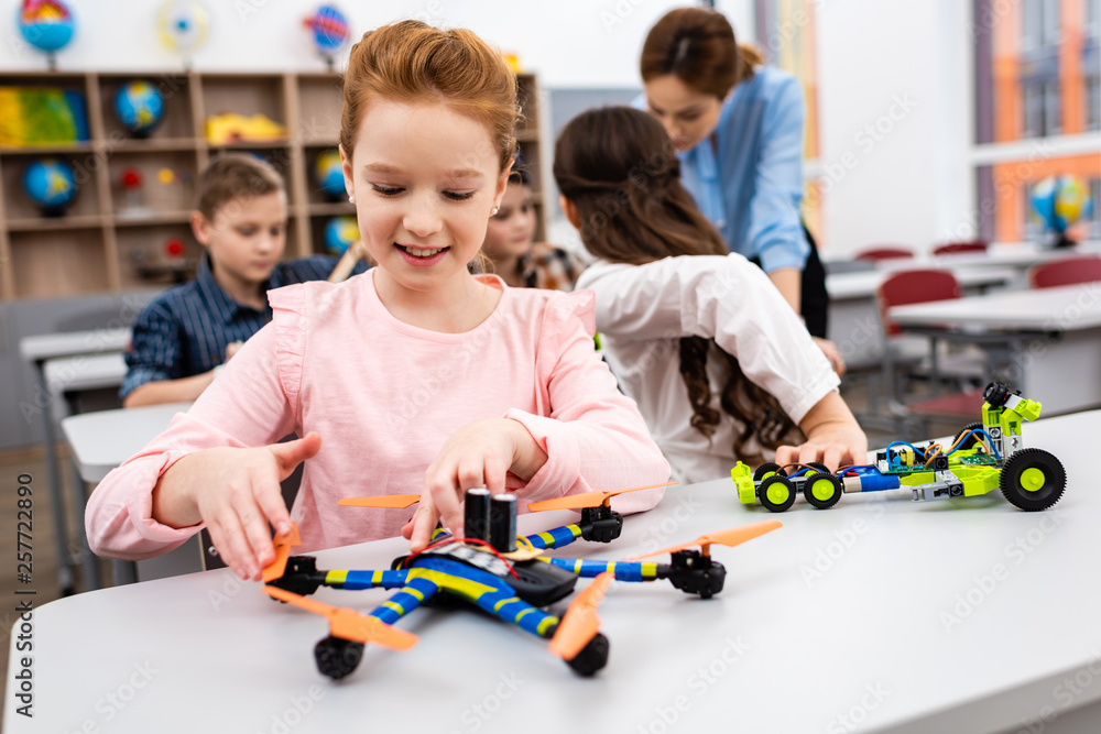 Pupils sitting at desk with educational toys during lesson in classroom Pupils sitting at desk with educational toys during lesson in classroom