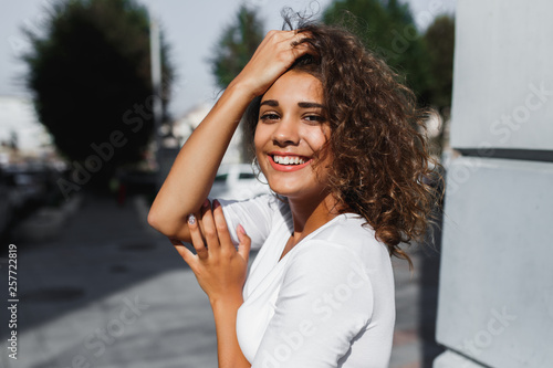 Portrait of smiling european woman with brunette curly hair photo