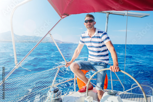 Young man sailing yacht. Holidays, people, travel © Max Topchii