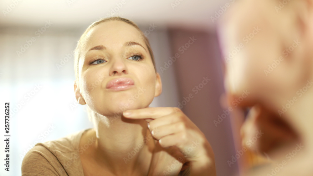 the girl looks in the mirror, dissatisfied with the appearance, pulls the skin. Ugly, aging skin. Allergy to cosmetics, fear of aging, circles under the eyes, wrinkles. Low self-esteem, dysmorphic dis the girl looks in the mirror, dissatisfied with the appearance, pulls the skin. Ugly, aging skin. Allergy to cosmetics, fear of aging, circles under the eyes, wrinkles. Low self-esteem, dysmorphic dis