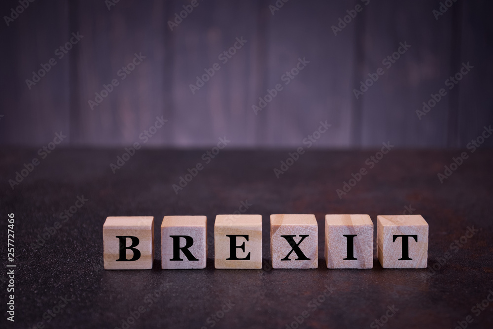 Obraz premium The word brexit on wooden cubes, light wooden cubes signs