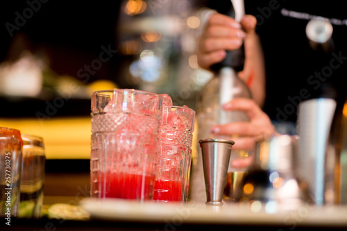 female bartender preparing cocktail in a cocktail bar