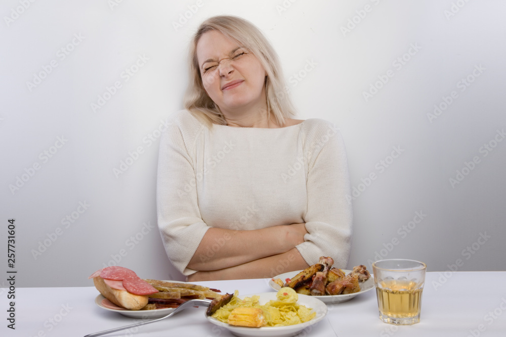the girl is suffering from abdominal pain. Digestive problems, stomach pain, diarrhea, constipation, nausea. An improper diet. Girl eat unhealthy fatty food the girl is suffering from abdominal pain. Digestive problems, stomach pain, diarrhea, constipation, nausea. An improper diet. Girl eat unhealthy fatty food
