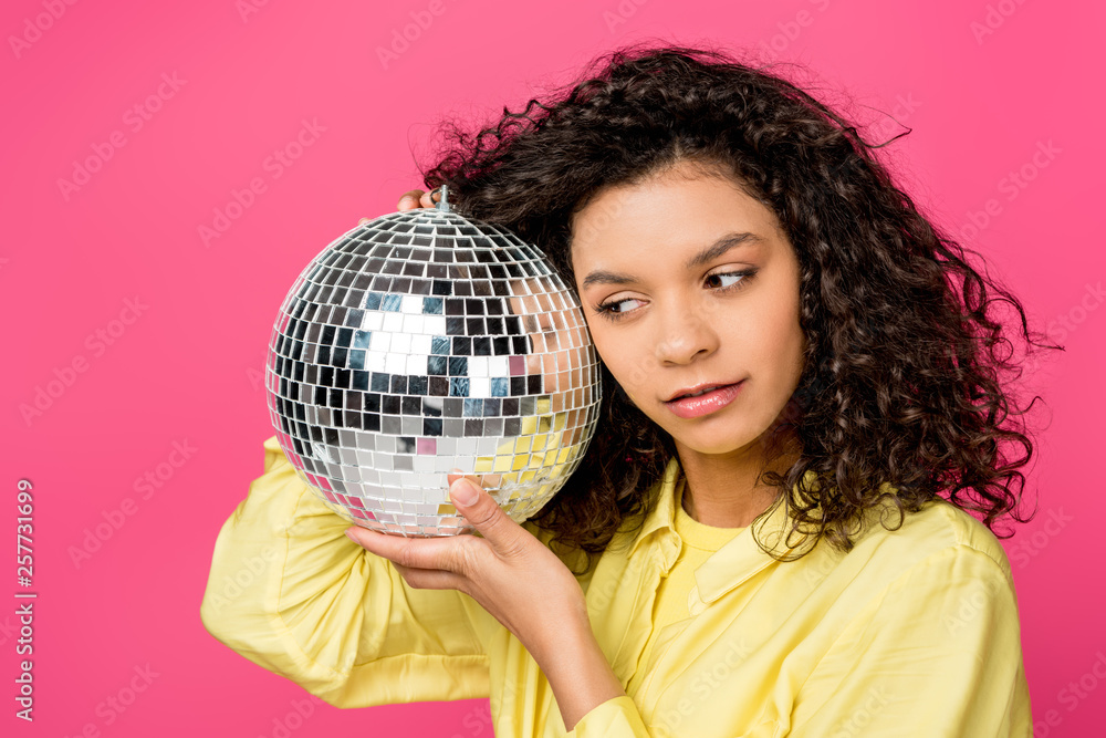 beautiful curly african american woman holding shiny disco ball isolated on crimson beautiful curly african american woman holding shiny disco ball isolated on crimson