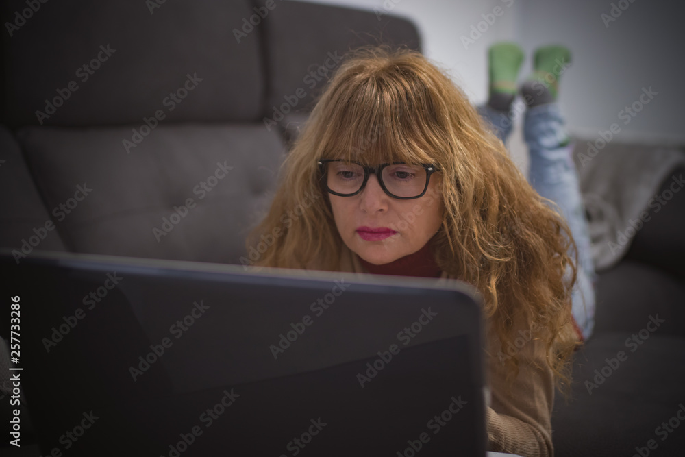 adult woman on the sofa with laptop adult woman on the sofa with laptop