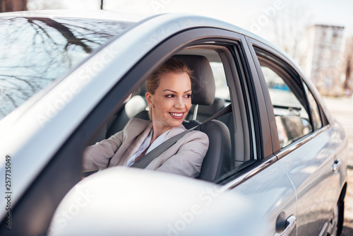 Beautiful woman driving a car. © bnenin