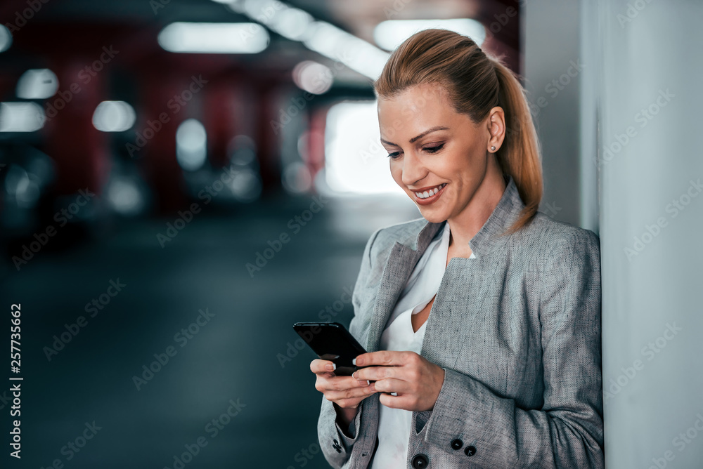 Portrait of a beautiful woman in a suit using mobile phone. Portrait of a beautiful woman in a suit using mobile phone.