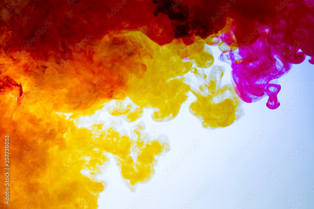 colorful paints dissolve in water, abstract background