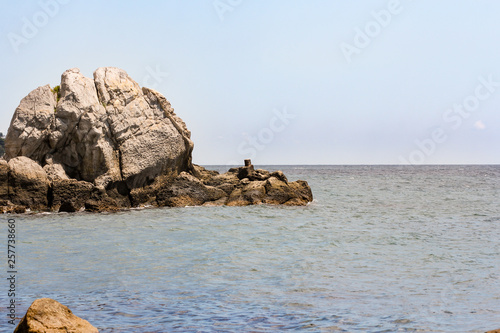 A large rock outstanding in the sea.