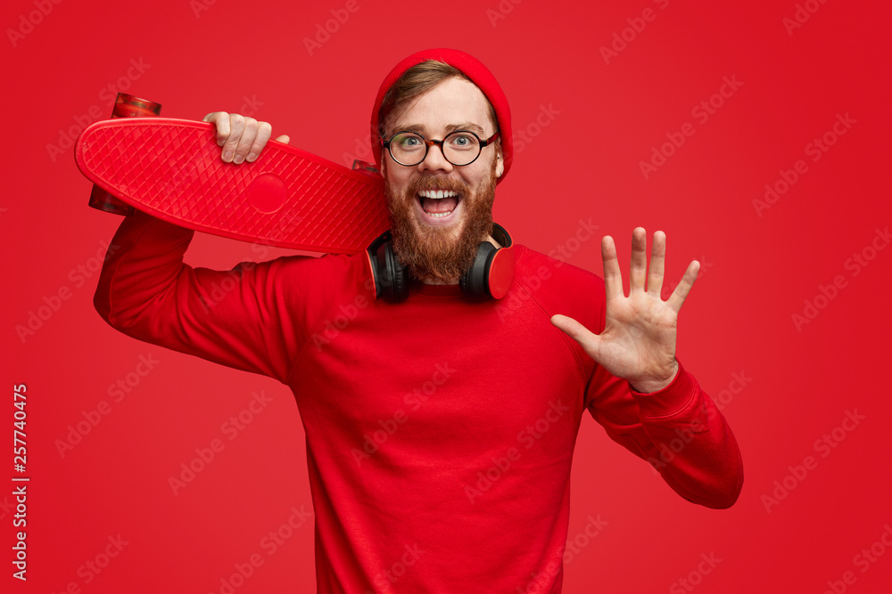 Fototapeta premium Hipster with skateboard waving hand