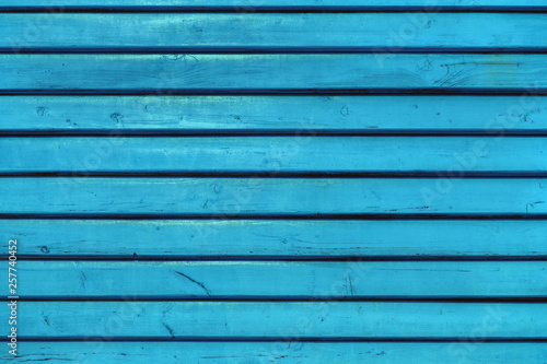 Blue vintage wooden boards in overlap cladding pattern