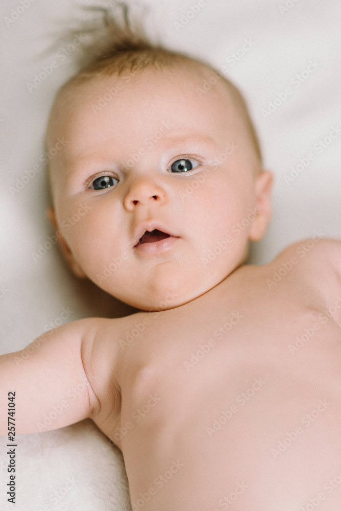 Portrait of cute newborn baby girl on white on blanket Portrait of cute newborn baby girl on white on blanket