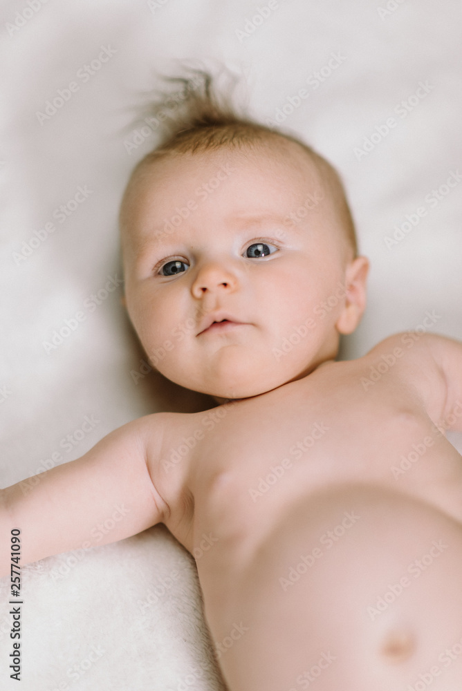 Portrait of cute newborn baby girl on white on blanket Portrait of cute newborn baby girl on white on blanket
