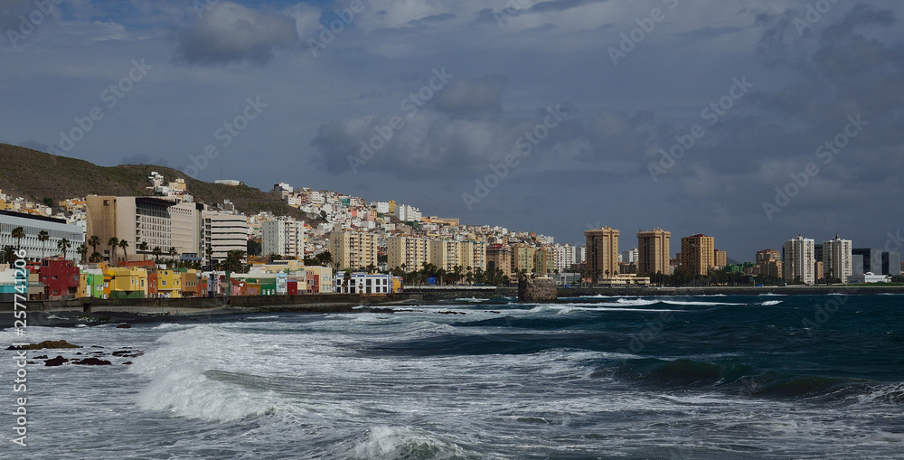 Coast with swell, city and cloudy sky, Las Palmas de Gran Canaria, Canary Islands