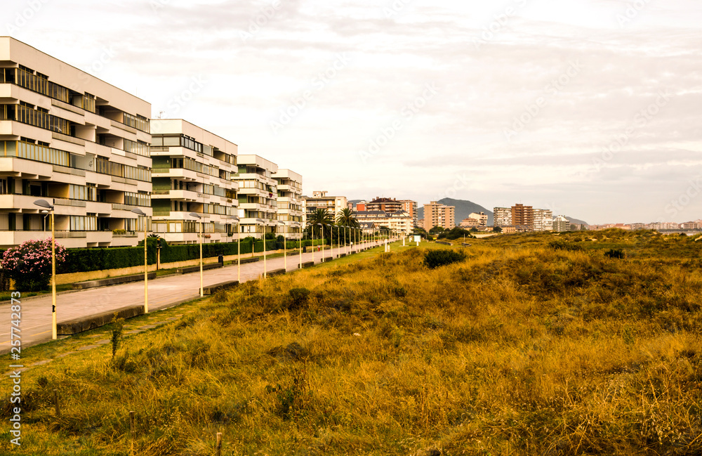 Big building in the north of Spain in a cloudy day. It´s surrounded by meadows.