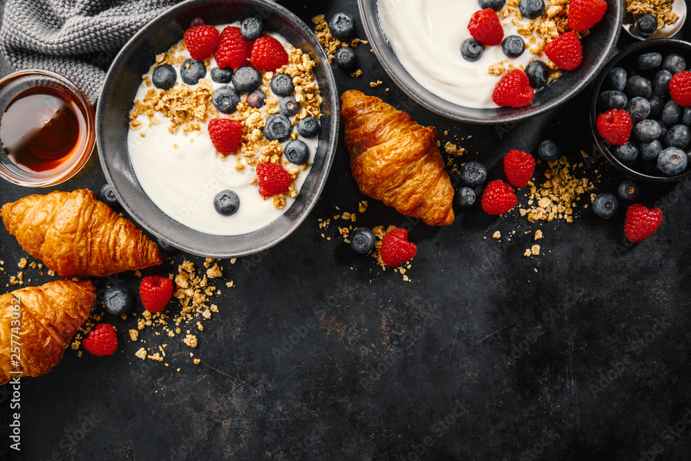 Yogurt with berries and granola in bowl Yogurt with berries and granola in bowl