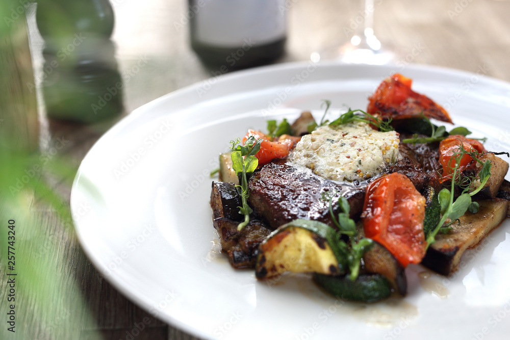 Exquisite, elegant dinner. Beef steak with herb butter and grilled vegetables Exquisite, elegant dinner. Beef steak with herb butter and grilled vegetables
