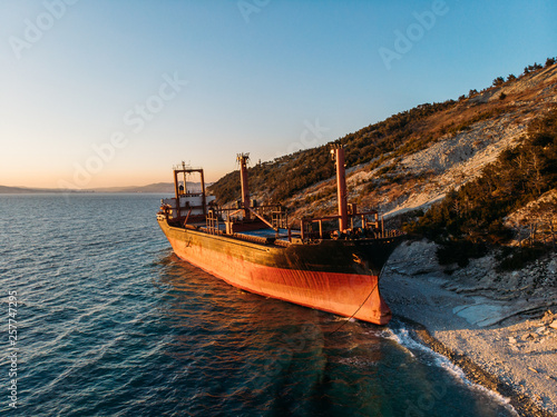 Cargo ship run aground at sea coastline near Novorossiysk and Gelendzhik. Shipwreck accident of nautical vessel after huge sea storm  aerial view