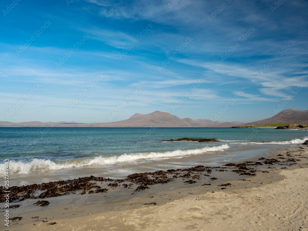 Irish west coast, beach  Connemara region, county Galway Ireland, peaks of Connemara in the background. Blue sky, sunny day,