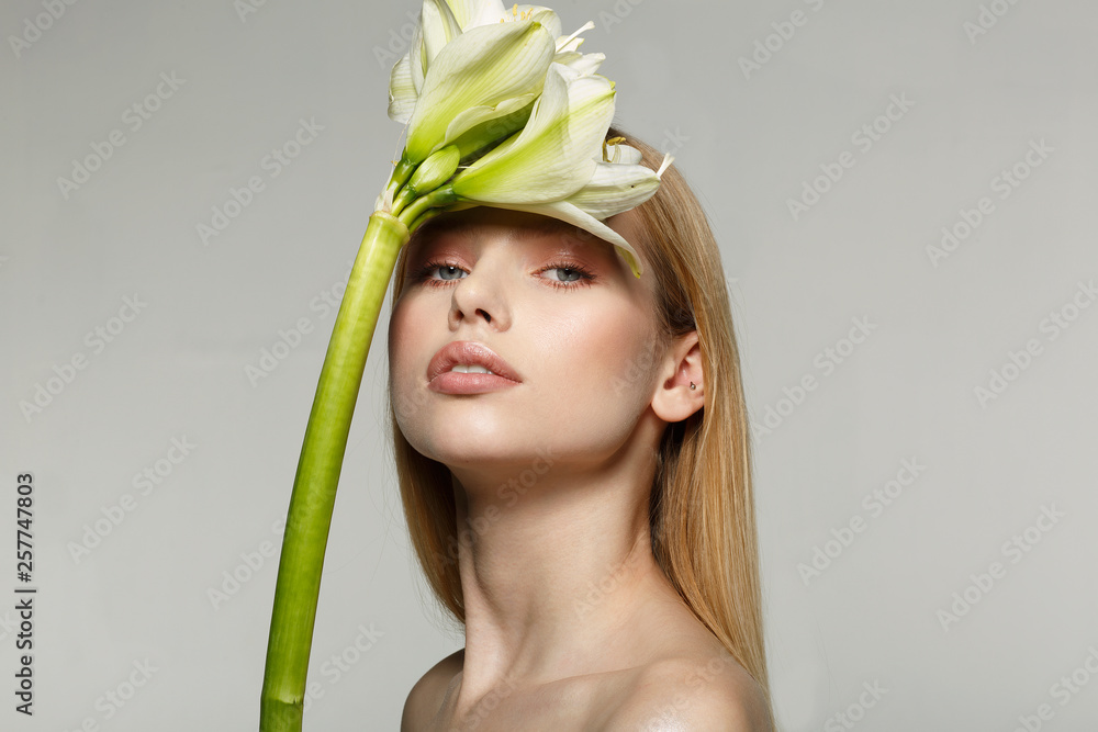 Naklejka premium Portrait of a young attractive girl with beautiful make-up, long hair, perfect skin