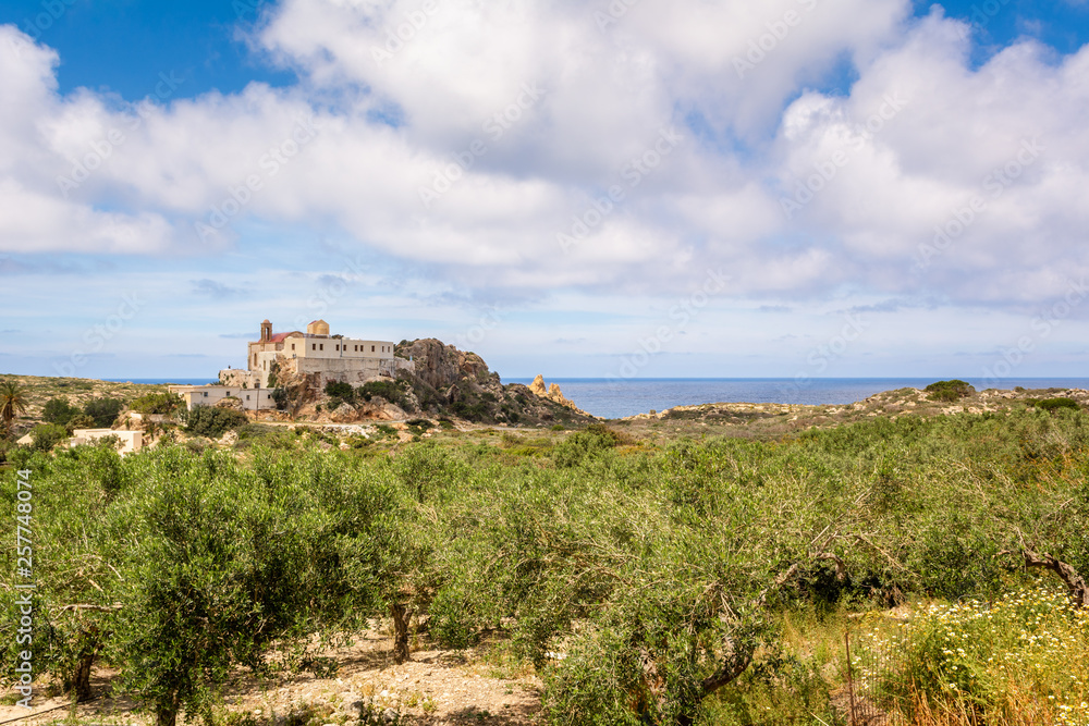 Fototapeta premium Chrisoskalitissa Monastery and olive groves located on the southwest coast of Crete, Greece.
