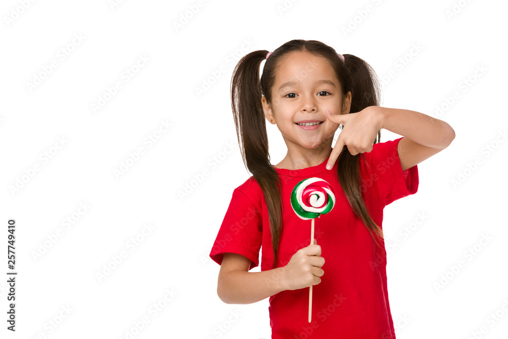Beautiful cute little child girl showing sweet candy lollipop isolated on white background Beautiful cute little child girl showing sweet candy lollipop isolated on white background