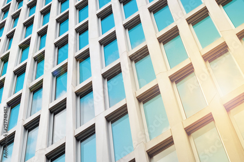 sun and sky reflection in office building facade, real estate concept -