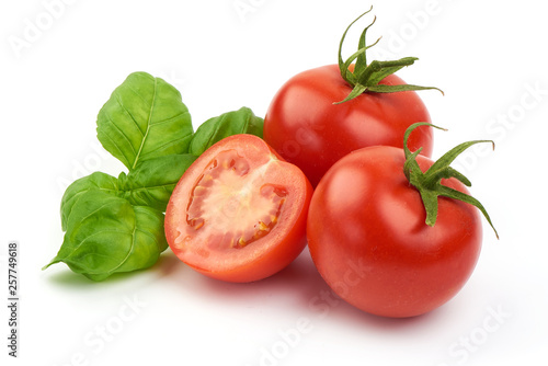 Fresh juicy tomatoes with Sweet basil leaves, close-up, isolated on white background