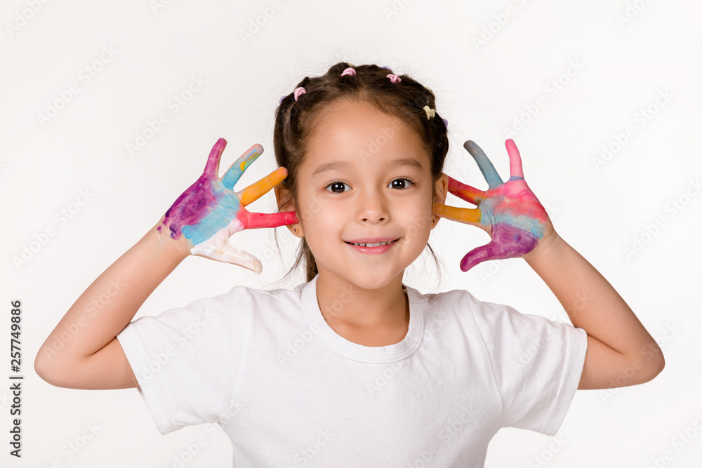 cute little child girl with hands painted in colorful paint isolated on white background. cute little child girl with hands painted in colorful paint isolated on white background.