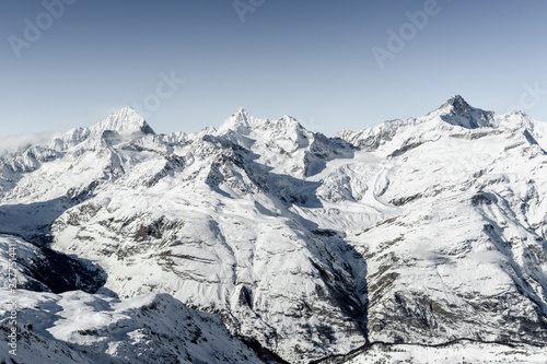Stunning view of winter Alpine mountains landscape in sunny bright day in Switzerland