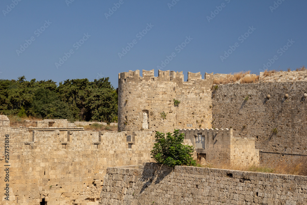 View of the fortress tower, decorated with a metope (sculpture). Gate of St. Athanasius. Rhodes, Greece.