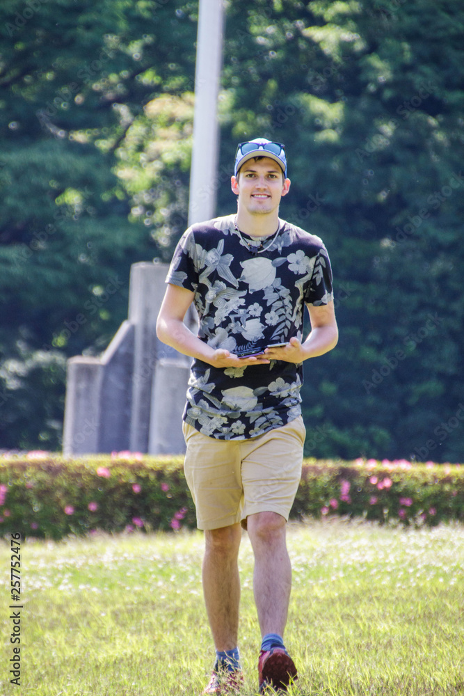 Naklejka premium young man walkng in the park