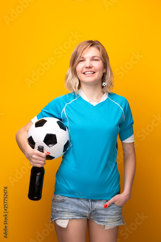 Photo of sports blonde holding in hand between ball and bottle of alcohol. © nuclear_lily