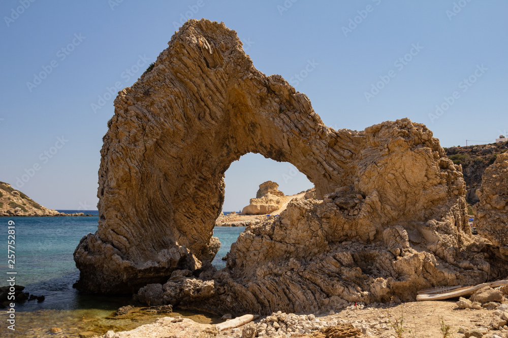 Natural arch on the Mediterranean coast. Rhodes Island, Greece.