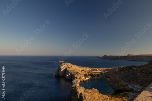 View from the Acropolis of Lindos on the bay of the Apostle Paul at sunset. Rhodes Island, Greece